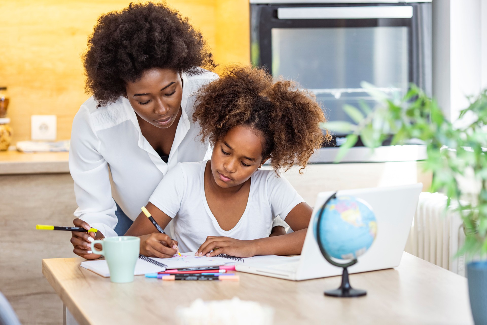 Mother and daughter learning indoors at home