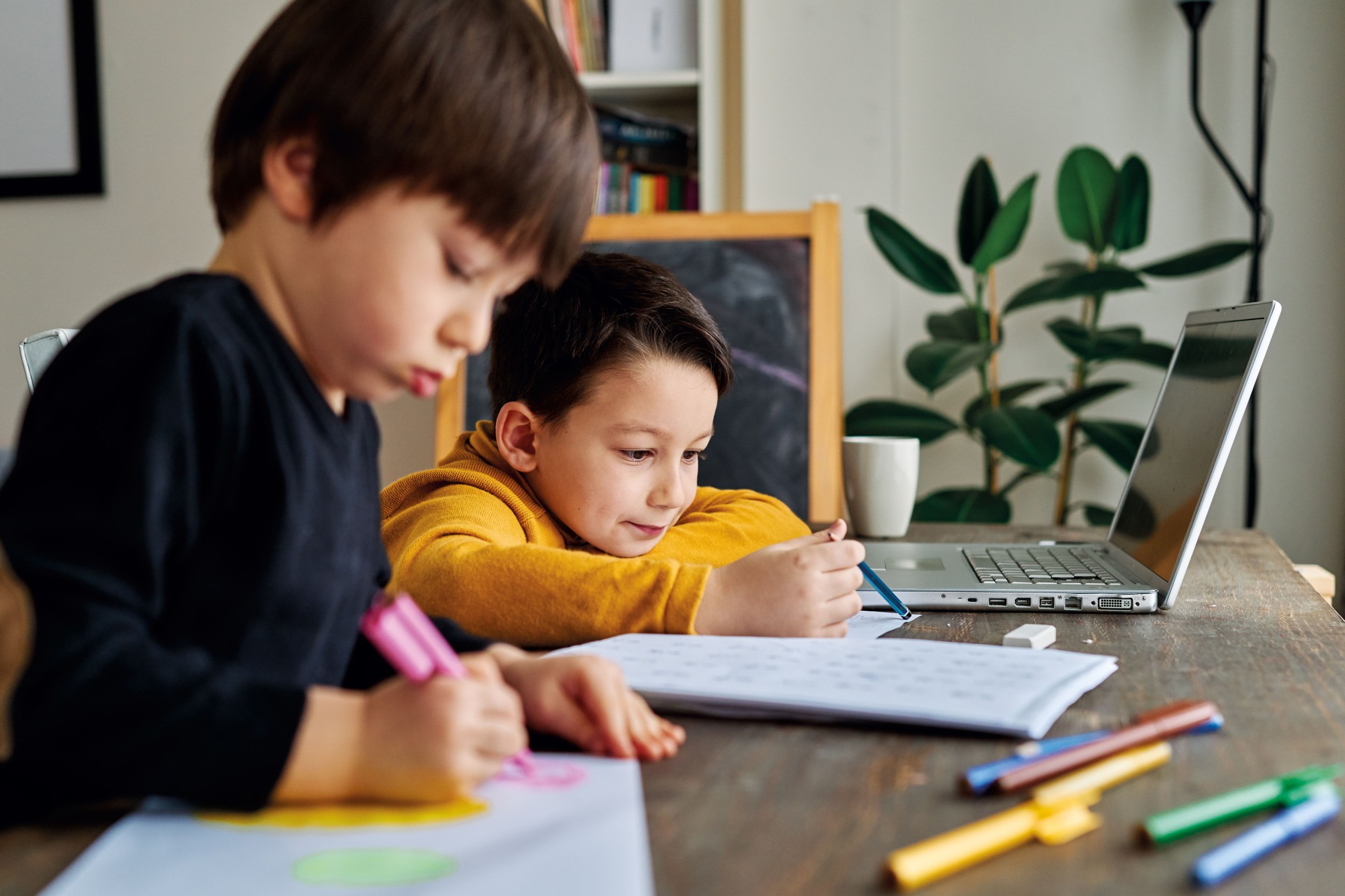 Education at home. Cute child learning mathematics at home with family.